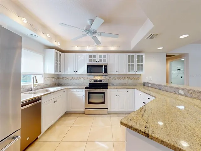 a kitchen with a sink stove and microwave