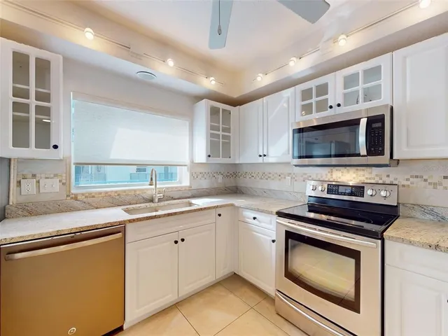 a kitchen with a sink stainless steel appliances and cabinets