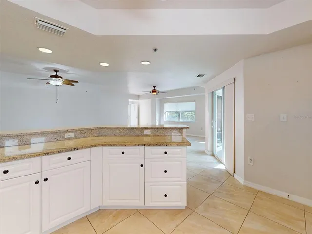 a kitchen with stainless steel appliances granite countertop a sink a stove and a refrigerator