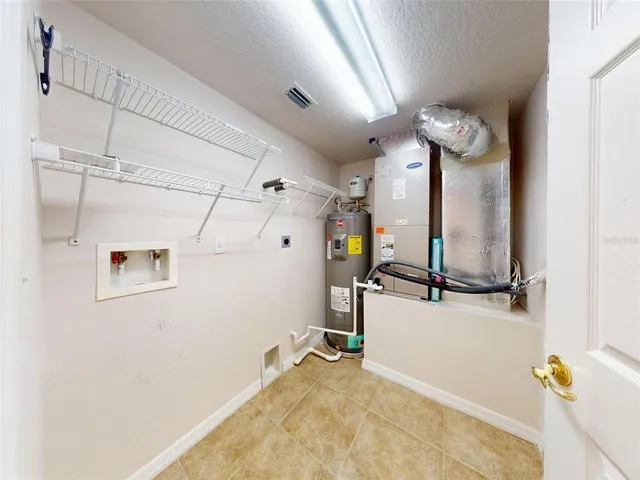 an empty room with fan and windows