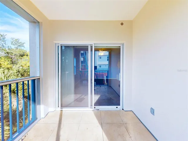 a view of a hallway with wooden floor and windows