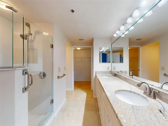 a bathroom with a tub a sink and shower