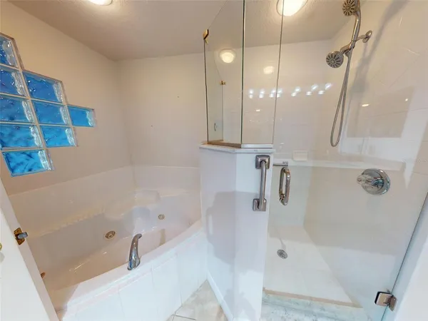 a bathroom with a granite countertop sink mirror and shower