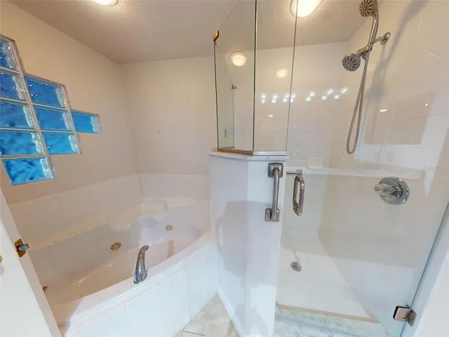 a bathroom with a granite countertop sink mirror and shower