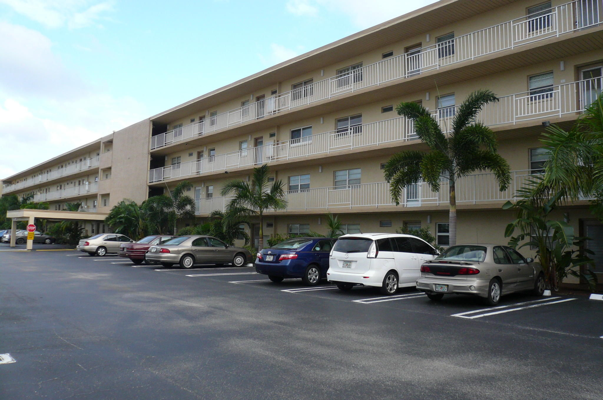330 Northeast 26th Avenue, Unit 212 Boynton Beach, FL 33435 - Photo 1 of 31 a view of a cars park in front of a building