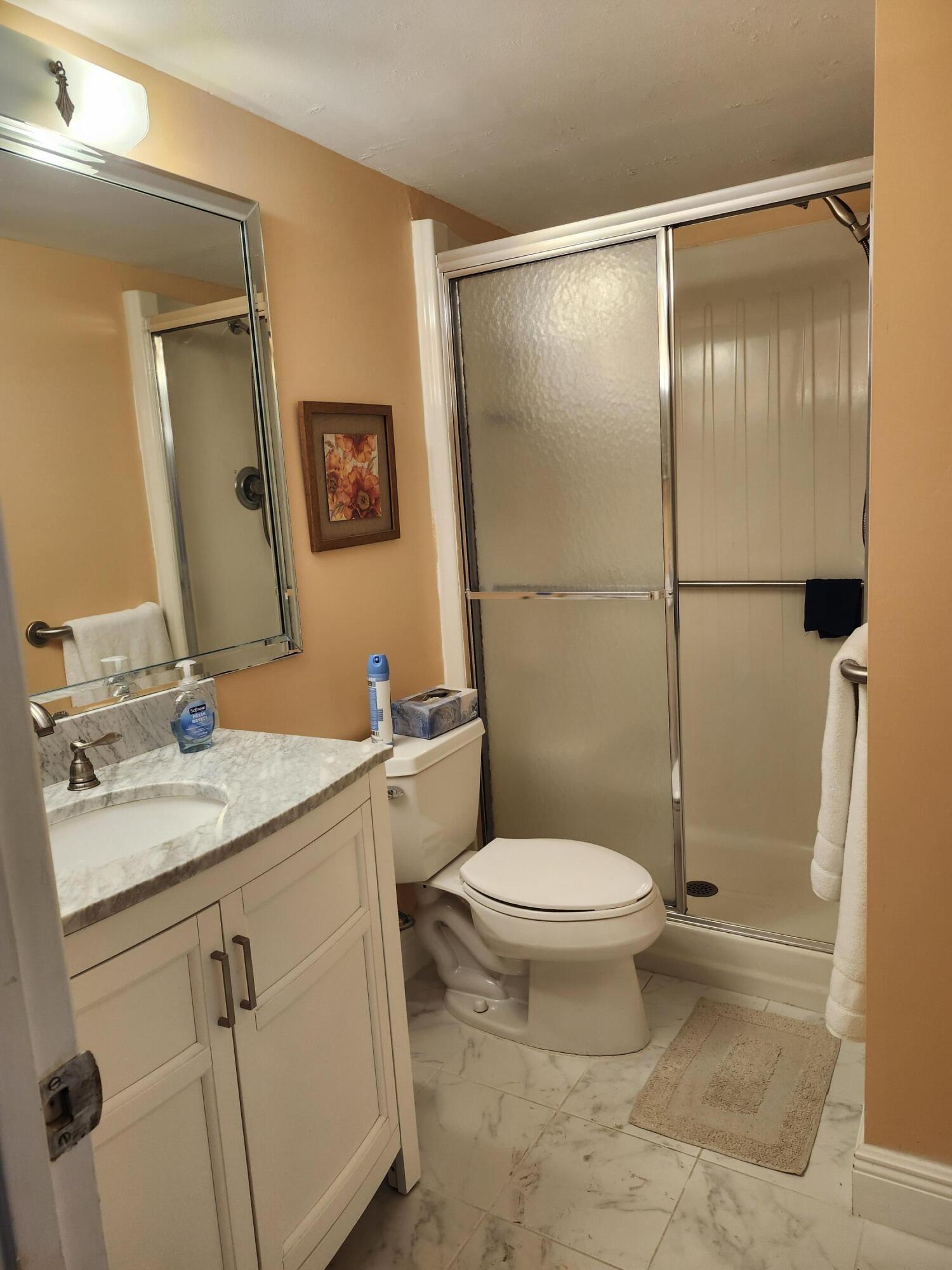 330 Northeast 26th Avenue, Unit 212 Boynton Beach, FL 33435 - Photo 11 of 31 a bathroom with a granite countertop sink toilet and shower