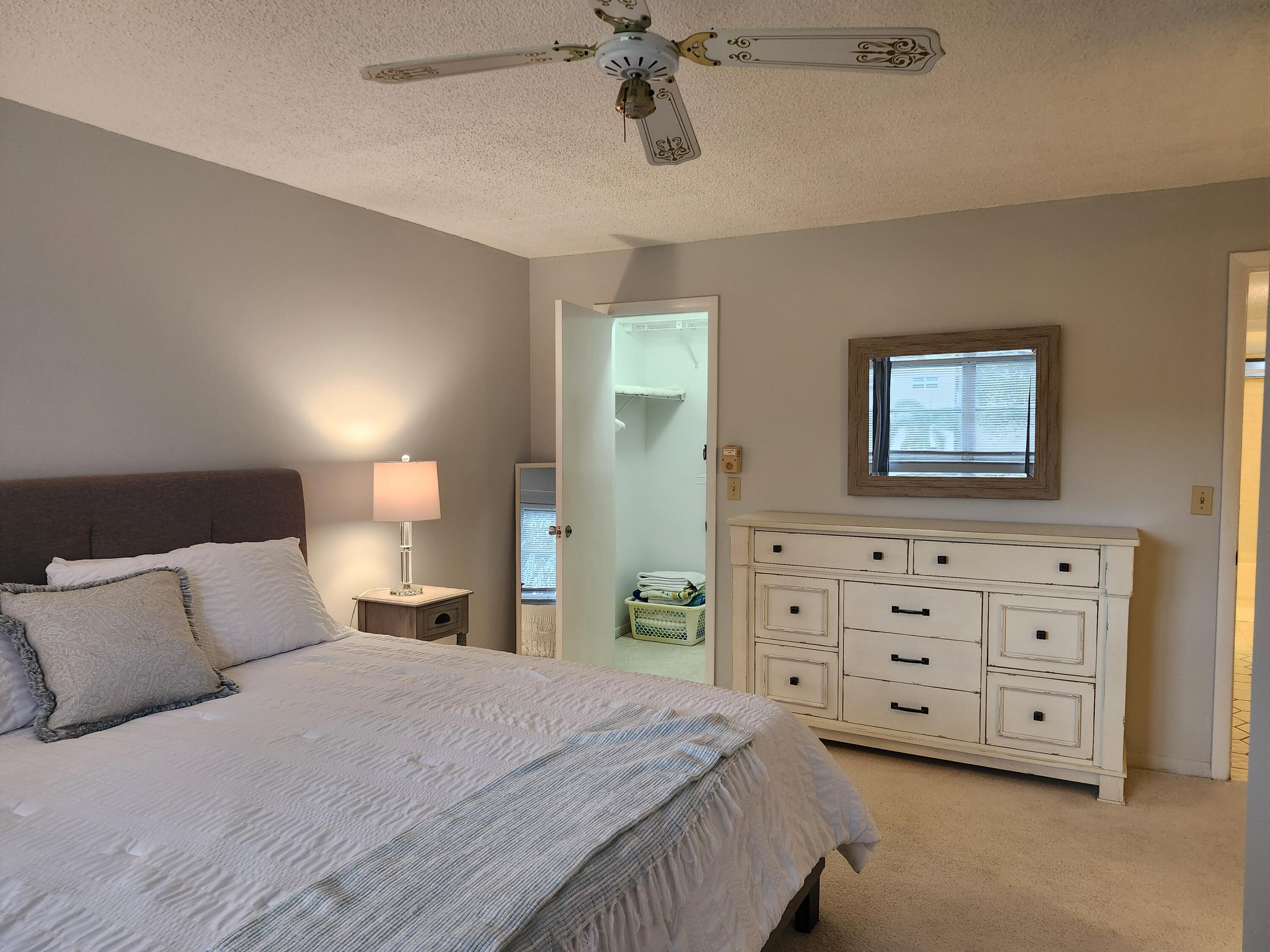 330 Northeast 26th Avenue, Unit 212 Boynton Beach, FL 33435 - Photo 12 of 31 a bedroom with a bed and a dresser