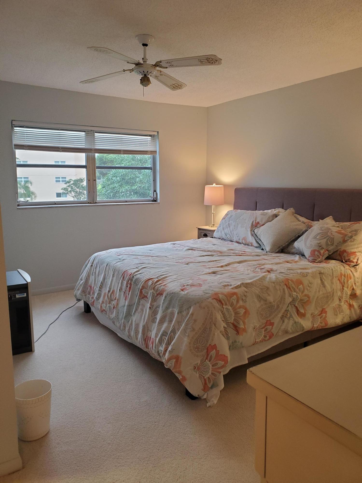 330 Northeast 26th Avenue, Unit 212 Boynton Beach, FL 33435 - Photo 13 of 31 a bedroom with a bed and window