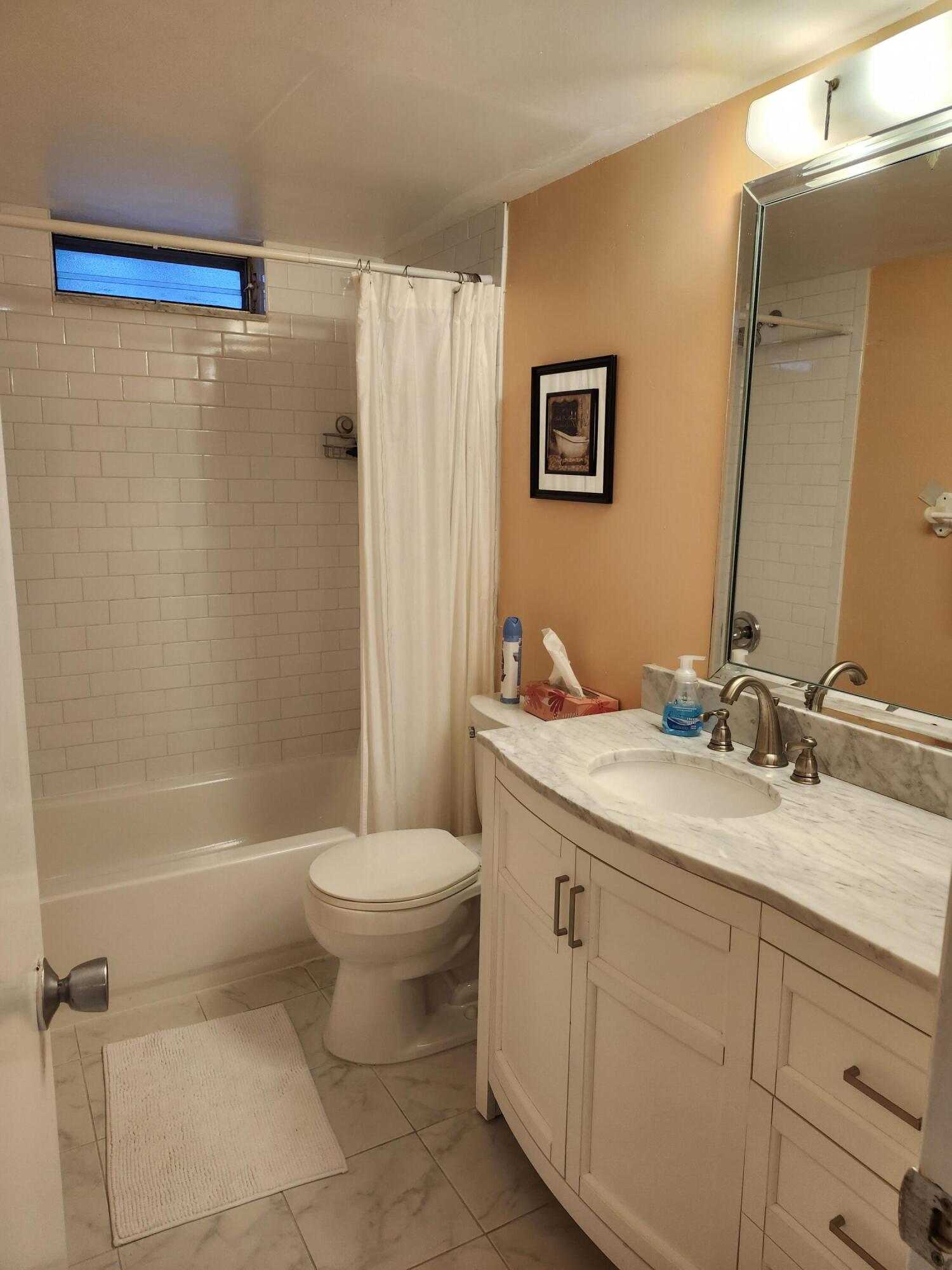 330 Northeast 26th Avenue, Unit 212 Boynton Beach, FL 33435 - Photo 17 of 31 a bathroom with a sink a toilet and a bathtub