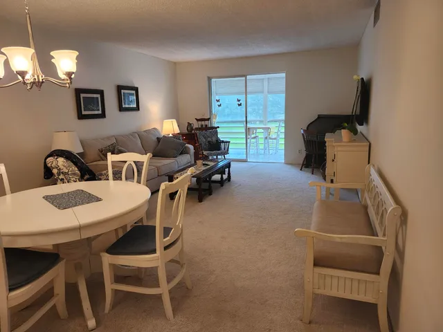 a dining room with furniture and a window