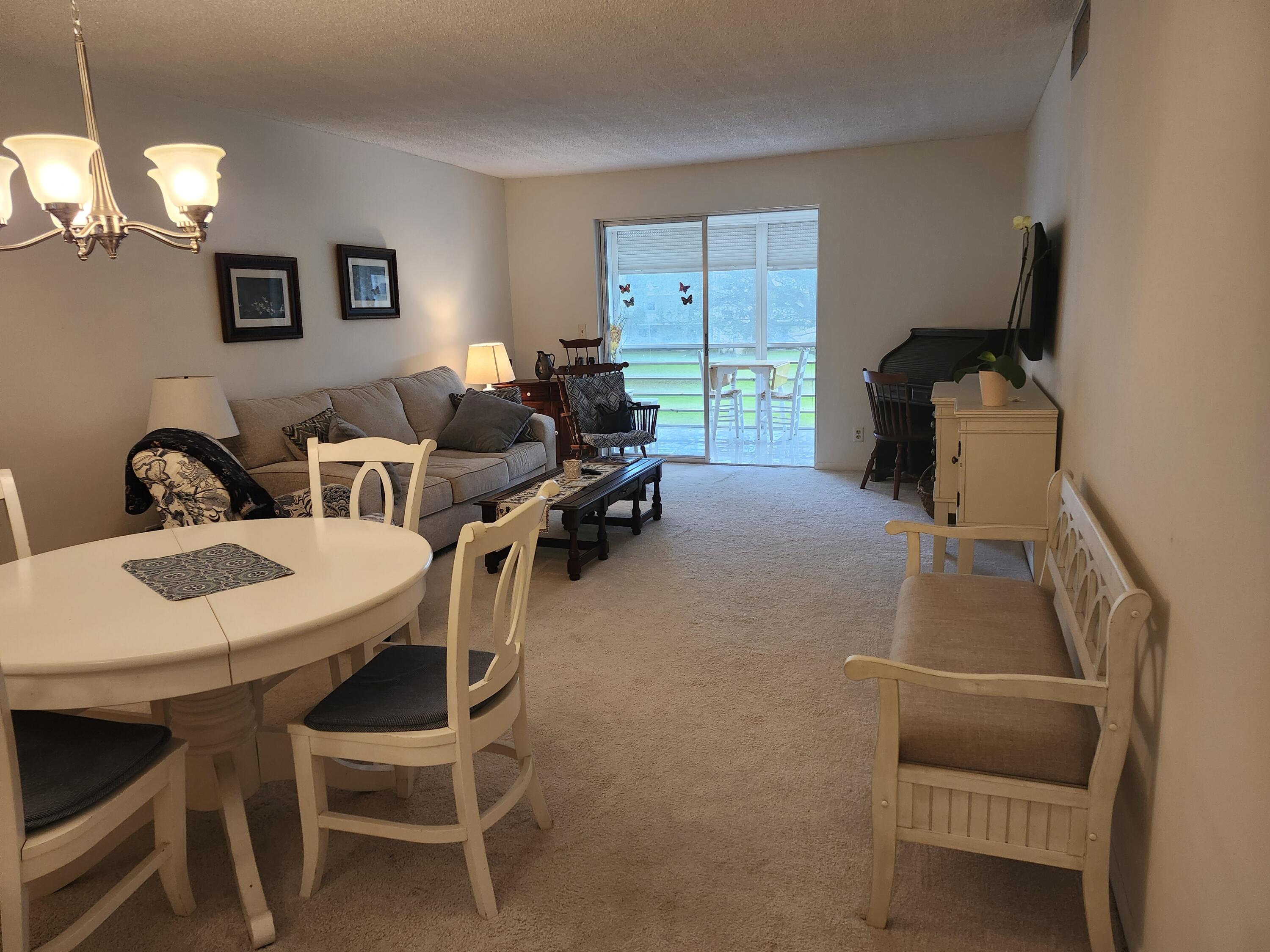 330 Northeast 26th Avenue, Unit 212 Boynton Beach, FL 33435 - Photo 5 of 31 a dining room with furniture and a window