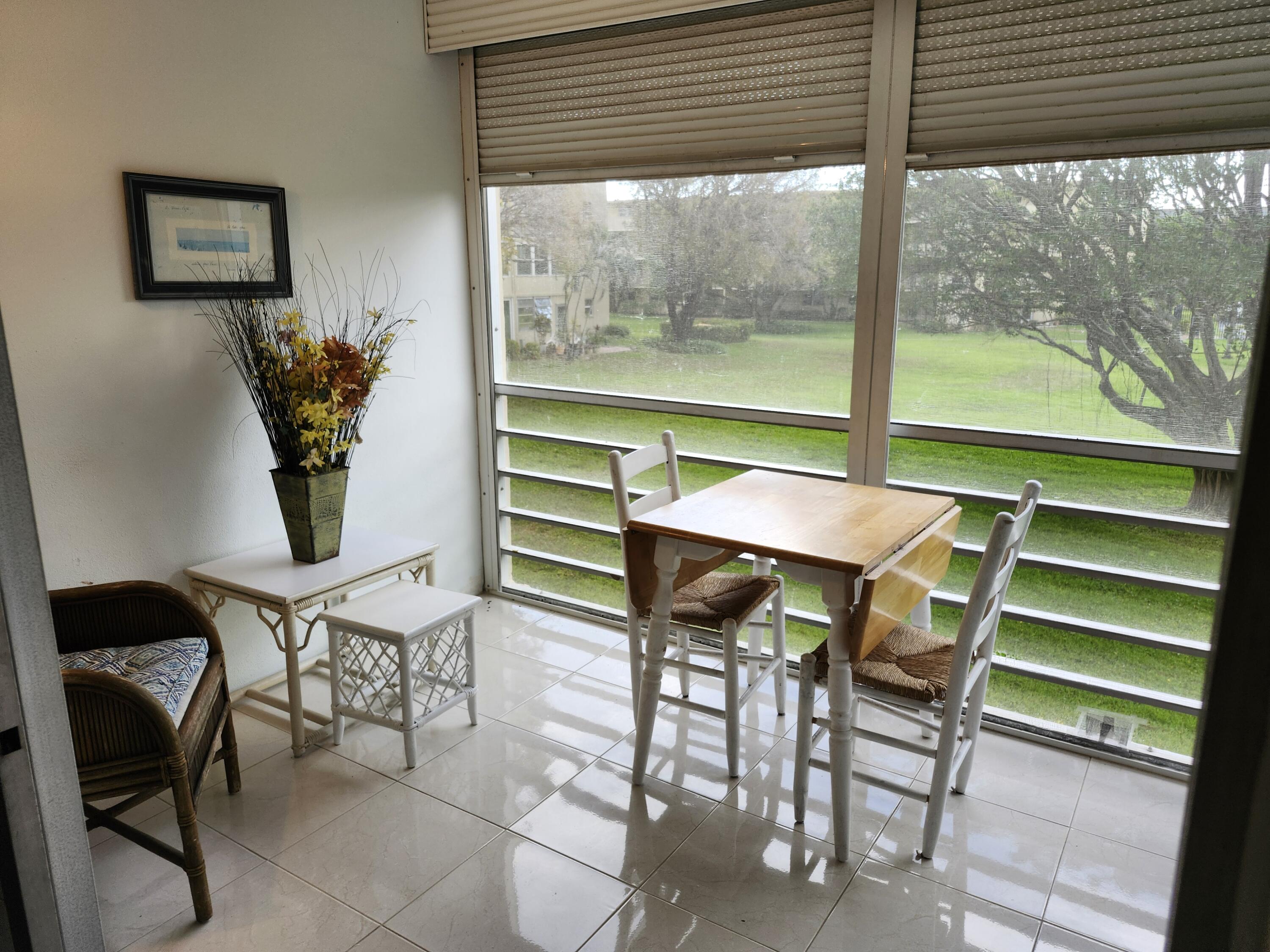 330 Northeast 26th Avenue, Unit 212 Boynton Beach, FL 33435 - Photo 6 of 31 a view of a dining room with furniture and a potted plant