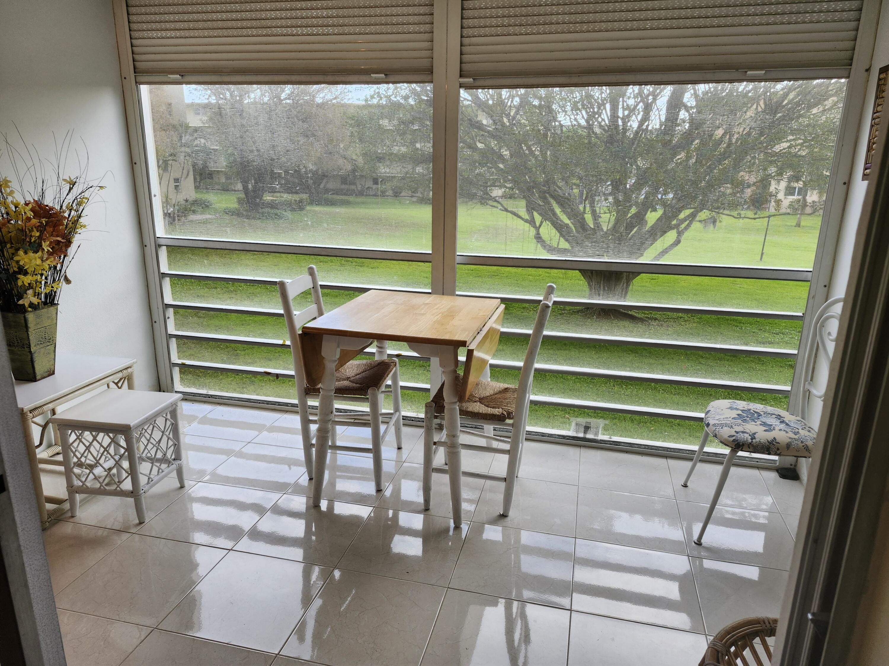 330 Northeast 26th Avenue, Unit 212 Boynton Beach, FL 33435 - Photo 7 of 31 a room with a table and chairs