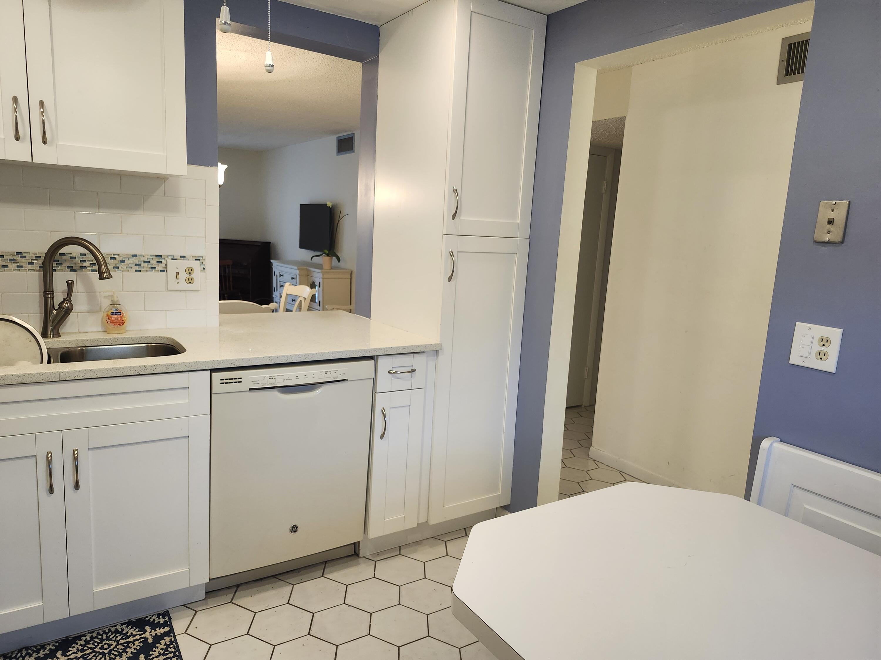 330 Northeast 26th Avenue, Unit 212 Boynton Beach, FL 33435 - Photo 9 of 31 a bedroom with a sink and a mirror