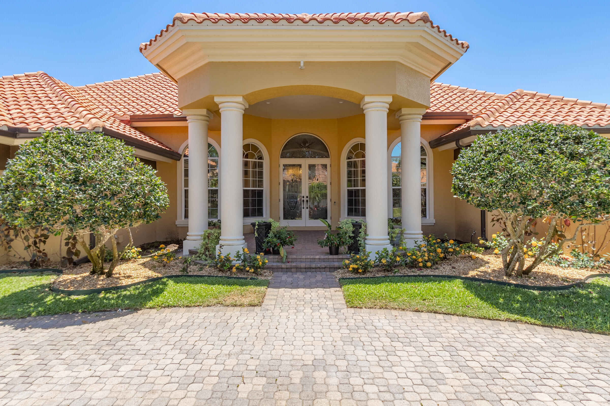 335 Normandy Drive Indialantic, FL 32903 - Photo 1 of 55 a front view of a house with garden
