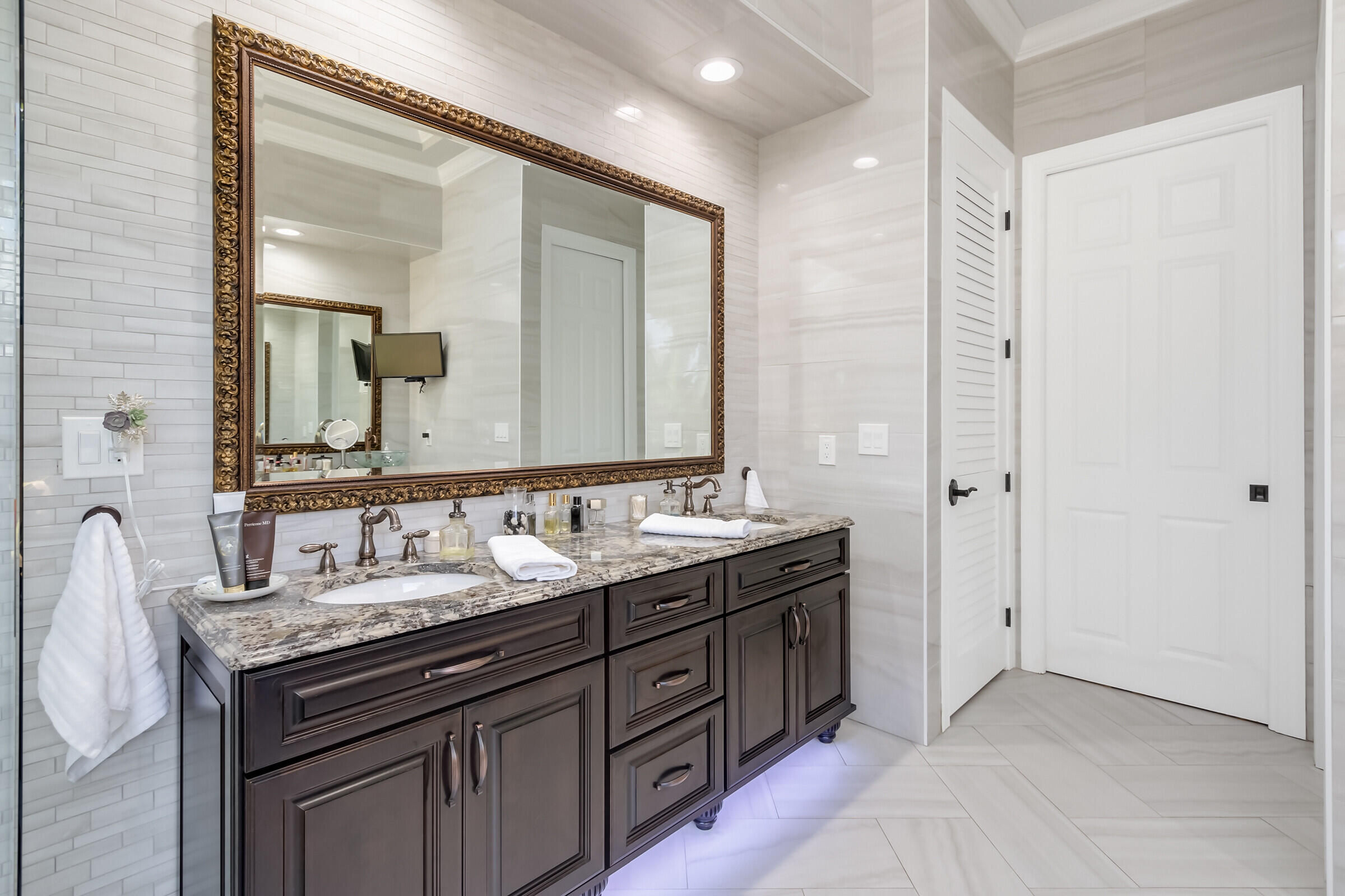 335 Normandy Drive Indialantic, FL 32903 - Photo 14 of 55 a bathroom with a double vanity sink and a mirror