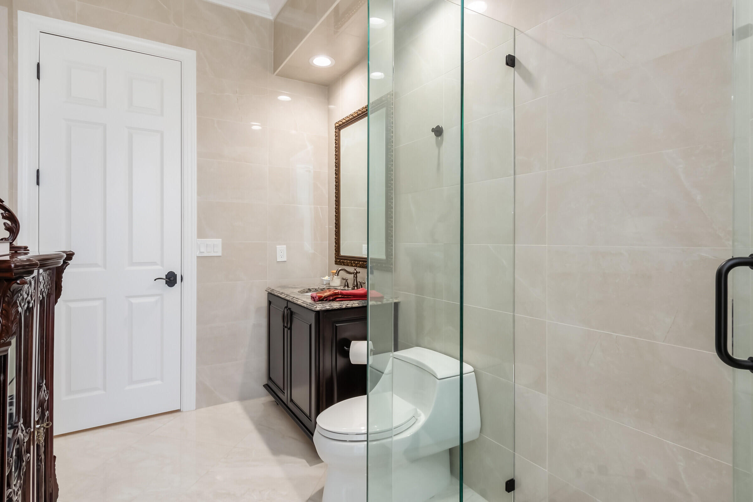 335 Normandy Drive Indialantic, FL 32903 - Photo 29 of 55 a bathroom with a granite countertop toilet a sink and a mirror