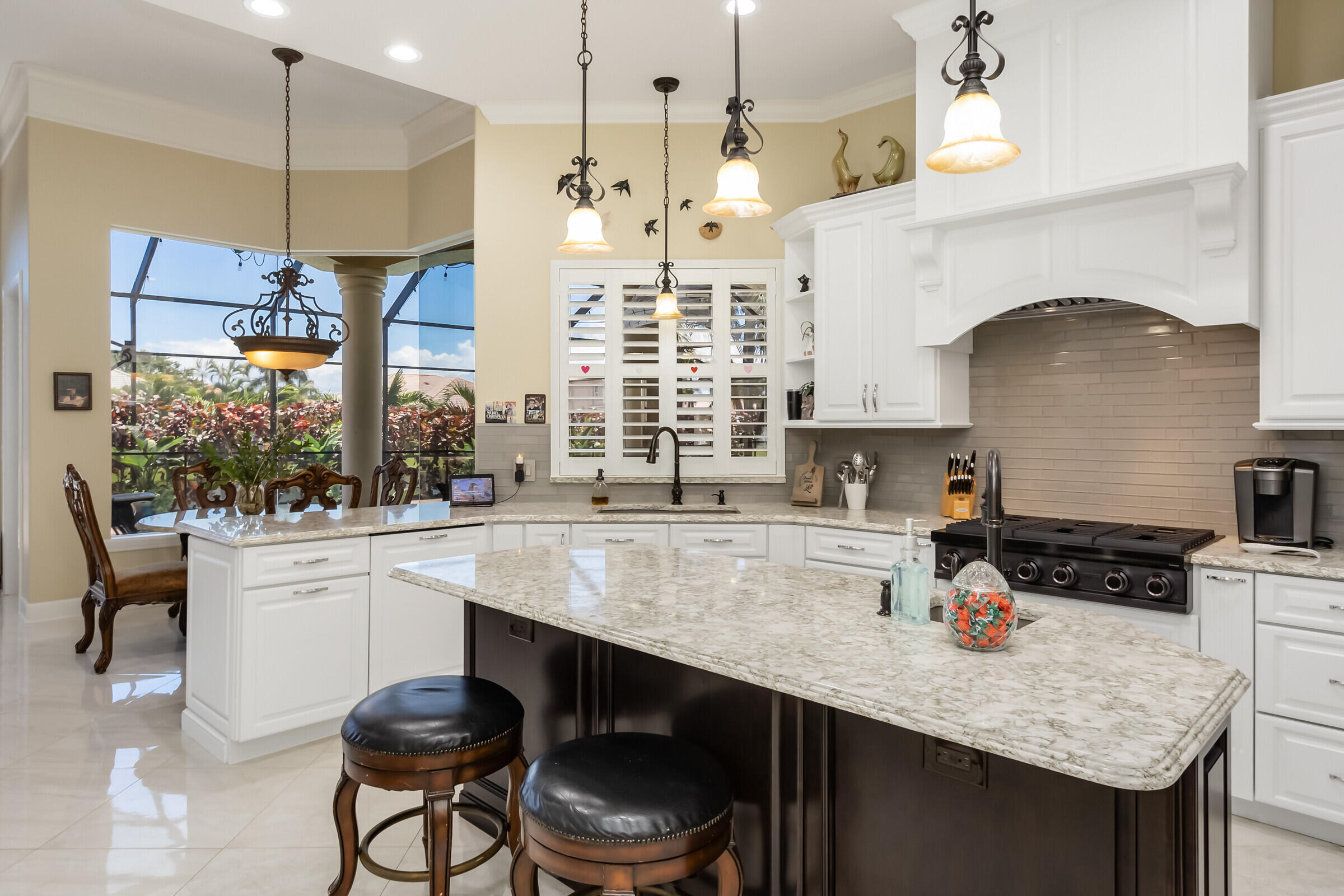 335 Normandy Drive Indialantic, FL 32903 - Photo 31 of 55 a kitchen with a sink a stove and chairs
