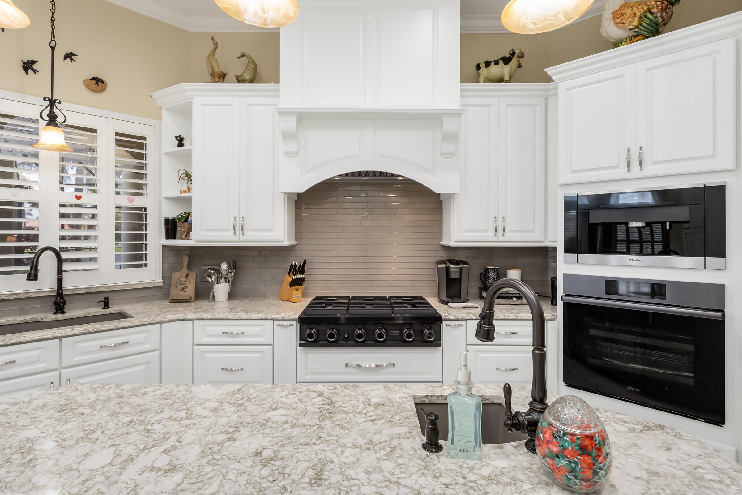 335 Normandy Drive Indialantic, FL 32903 - Photo 32 of 55 a kitchen with white cabinets and appliances