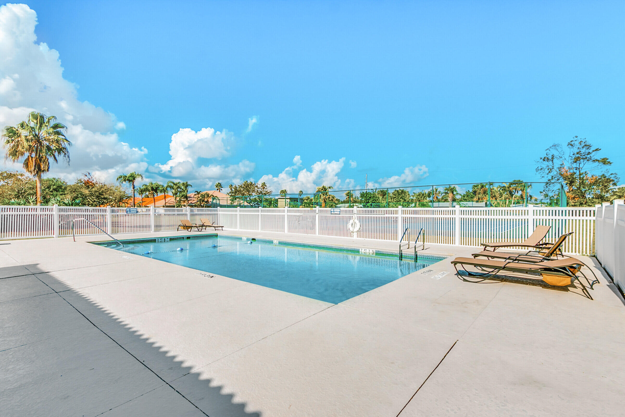 335 Normandy Drive Indialantic, FL 32903 - Photo 44 of 55 a view of a swimming pool with an outdoor seating and a garden