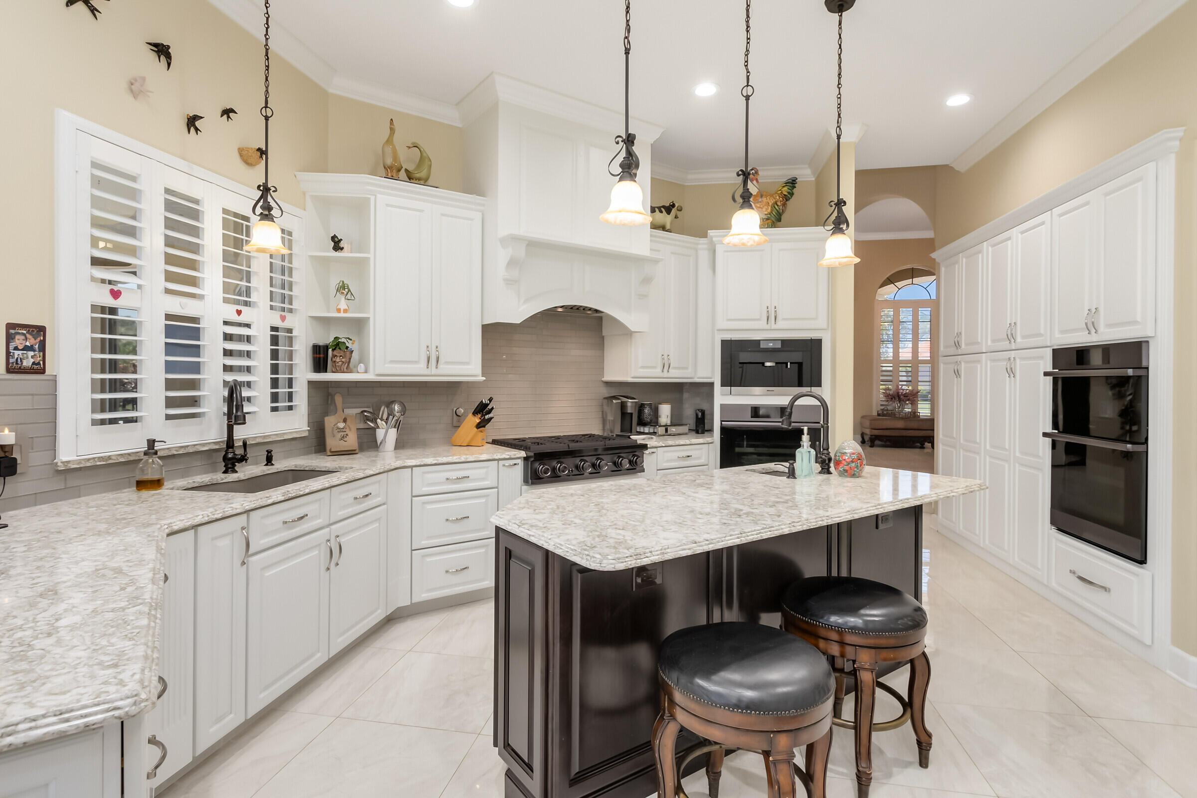 335 Normandy Drive Indialantic, FL 32903 - Photo 6 of 55 a open kitchen with stainless steel appliances granite countertop a sink a stove a refrigerator a center island a stove and a cabinets