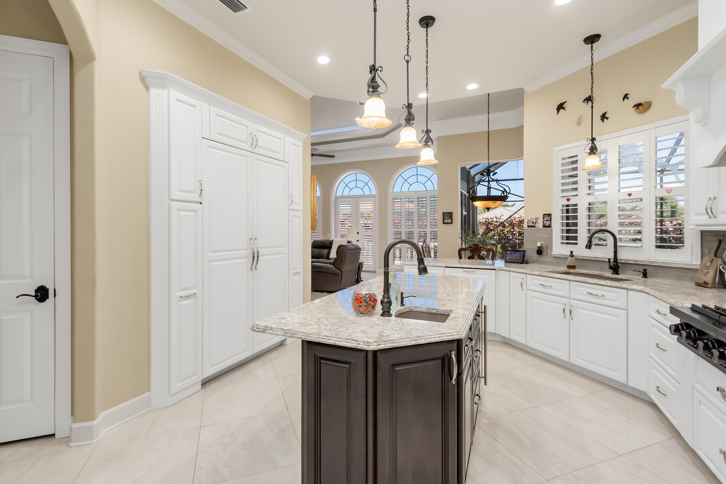 335 Normandy Drive Indialantic, FL 32903 - Photo 7 of 55 a large kitchen with granite countertop a sink and a refrigerator