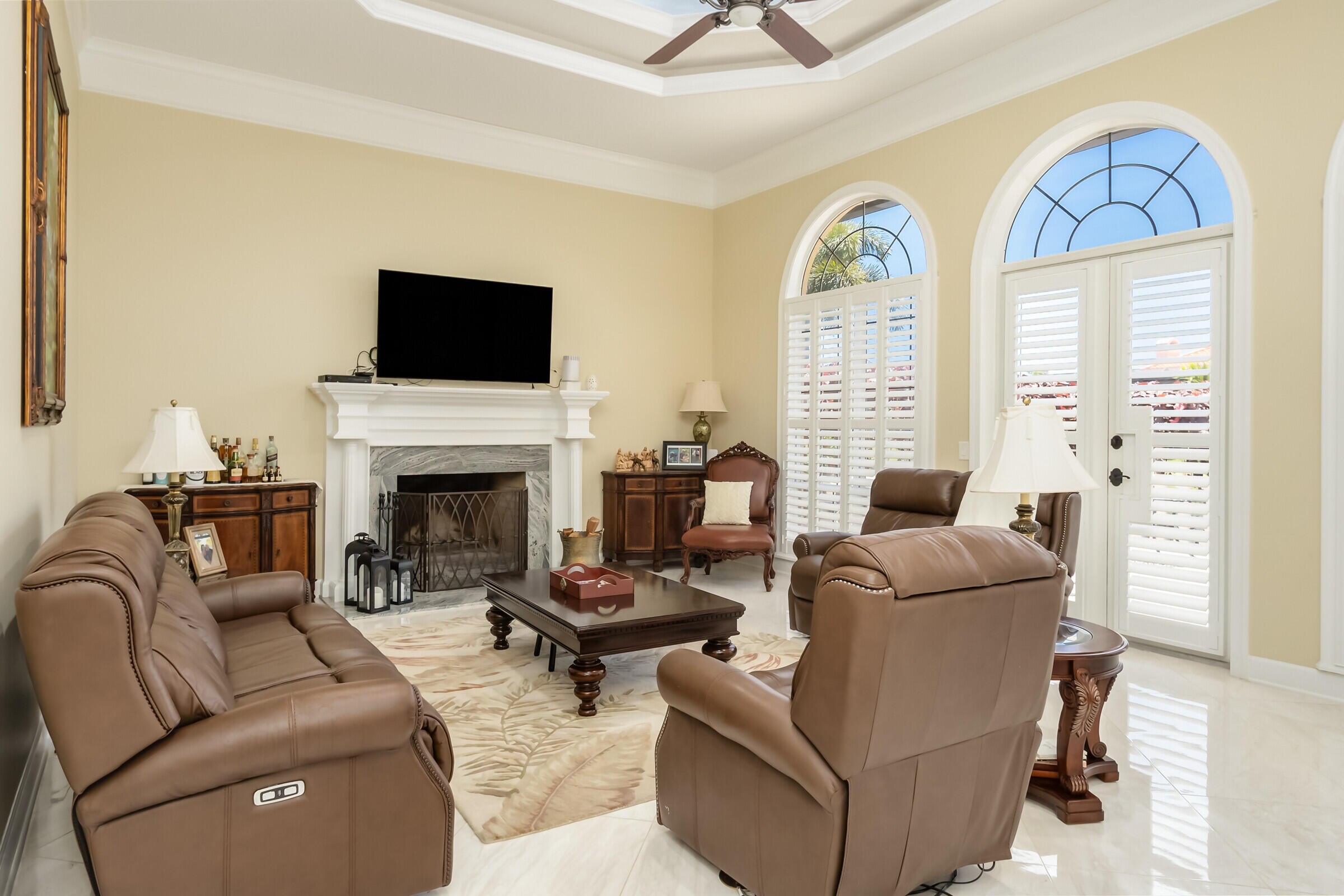 335 Normandy Drive Indialantic, FL 32903 - Photo 9 of 55 a living room with furniture a flat screen tv and a fireplace