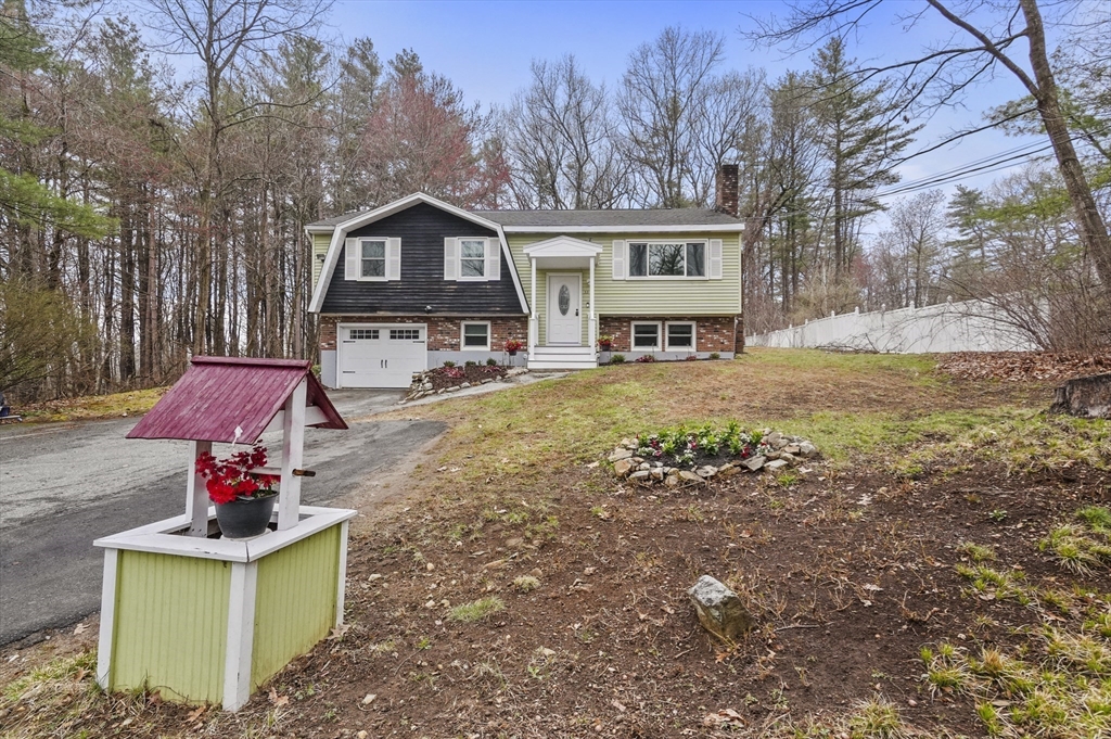 33 Frost Road Derry, NH 03038 - Photo 1 of 30 a front view of a house with garden