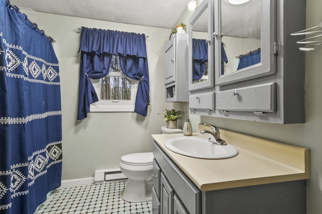 33 Frost Road Derry, NH 03038 - Photo 14 of 30 a bathroom with a sink a toilet and shower