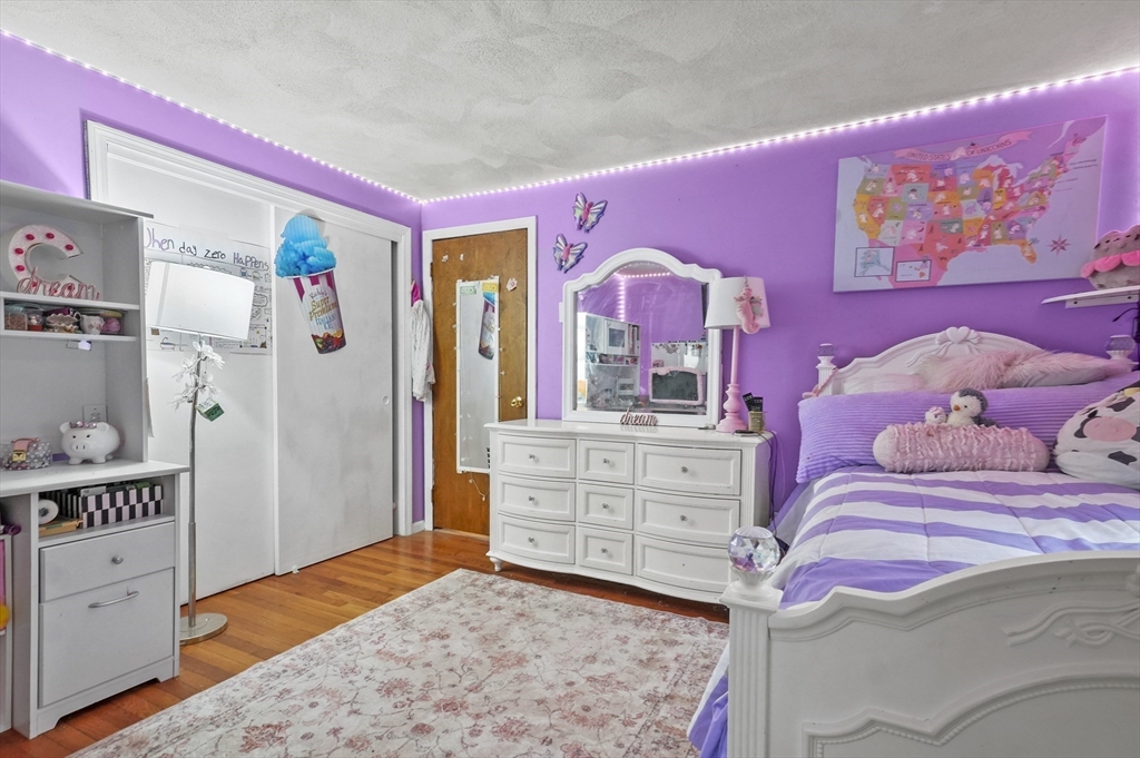 33 Frost Road Derry, NH 03038 - Photo 19 of 30 a bedroom with a bed and a dresser in it