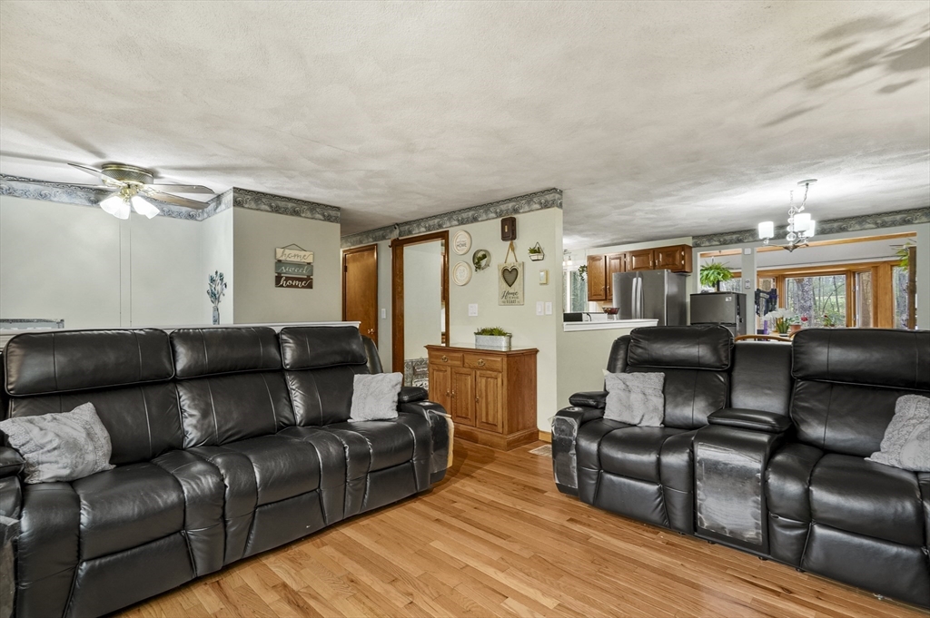 33 Frost Road Derry, NH 03038 - Photo 4 of 30 a living room with furniture and a wooden floor