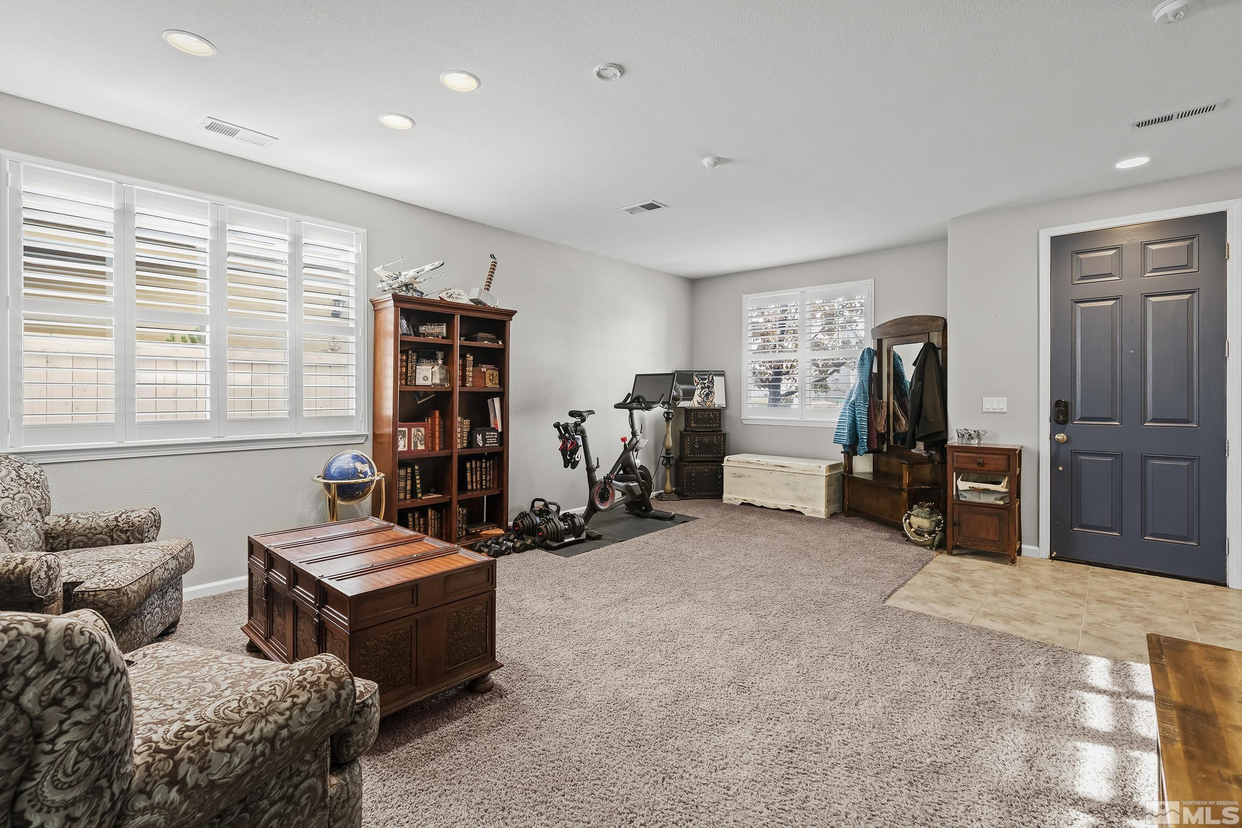 10806 Oakhaven Drive Reno, NV 89521 - Photo 4 of 27 a living room with furniture a window and gym equipment