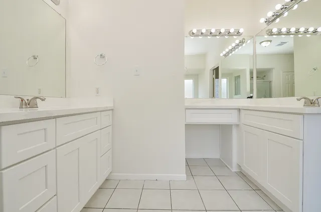 a bathroom with a sink vanity and mirror