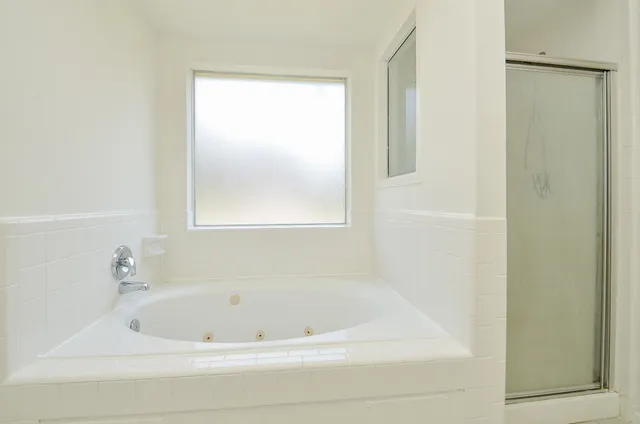 a white bath tub sitting next to a window