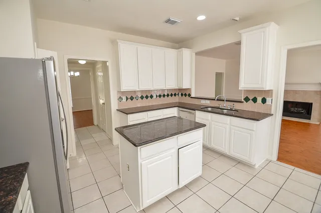 a kitchen with a sink stove and cabinets