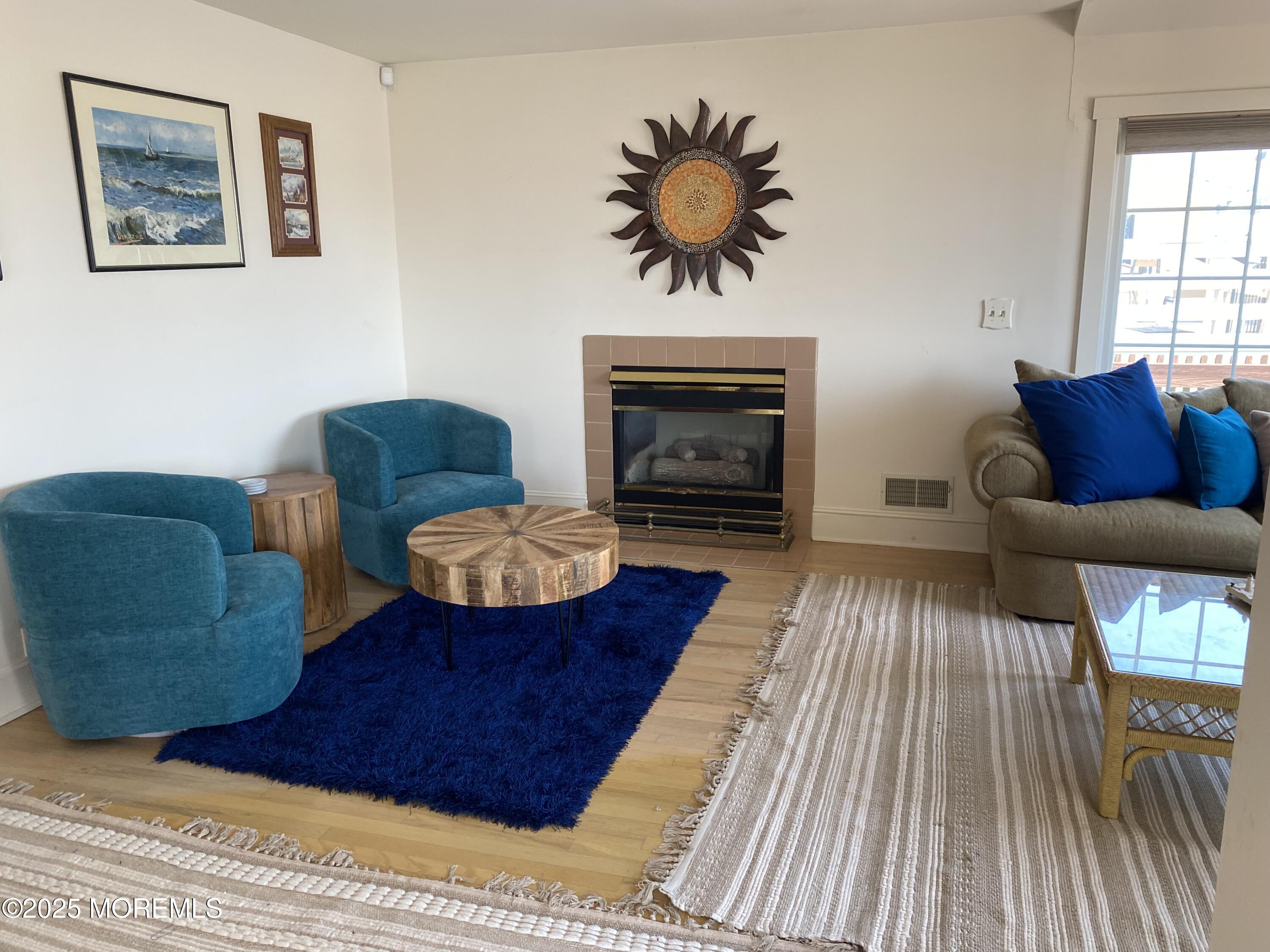 115 Boardwalk Point Pleasant Beach, NJ 08742 - Photo 17 of 23 a living room with furniture and a fireplace