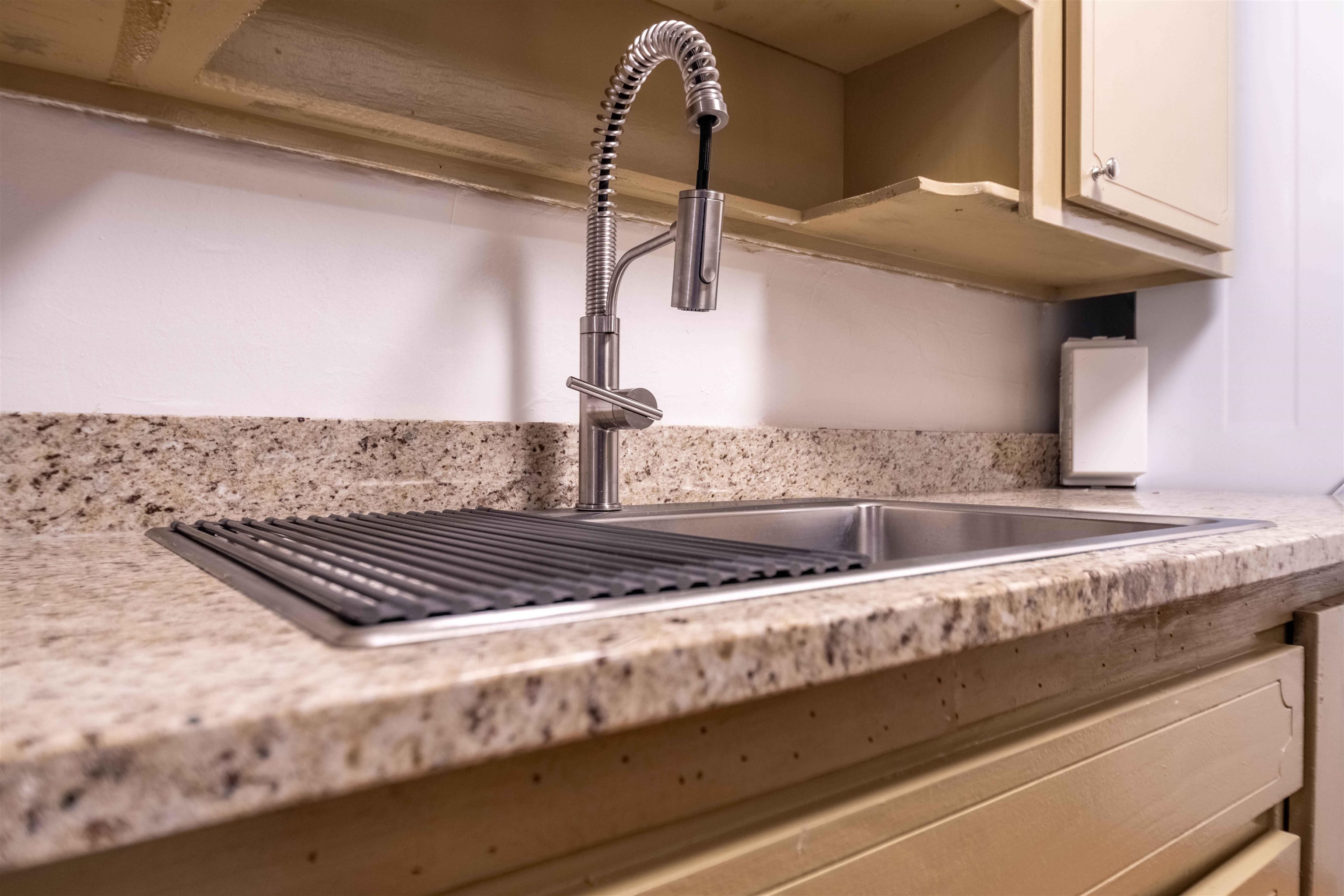 3080 Walnut Grove Road, Unit 306 Memphis, TN 38111 - Photo 9 of 18 Stainless steel sink with an integrated drying rack, complemented by a contemporary pull-down faucet