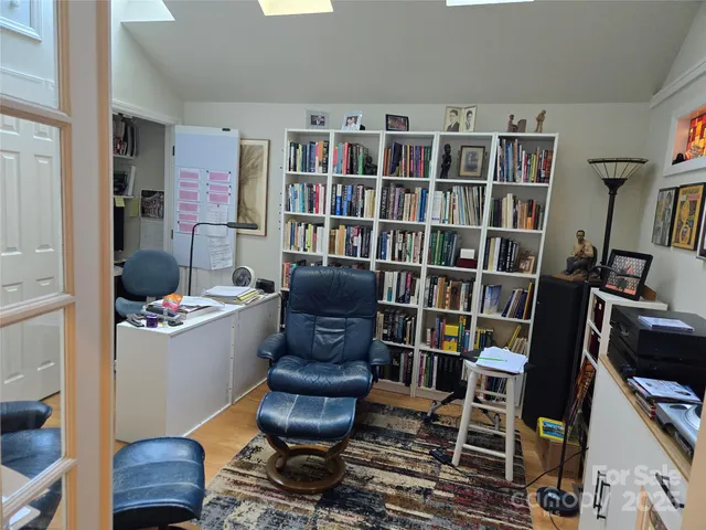 a living room with furniture and a book shelf