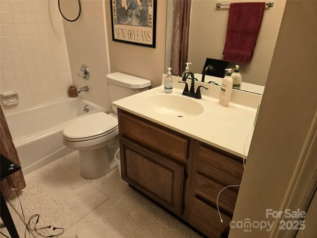 a bathroom with a sink vanity mirror and toilet
