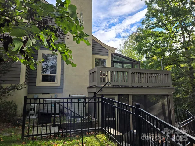 a view of a house with wooden deck and furniture