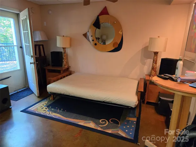 a bed sitting in a bedroom next to a window