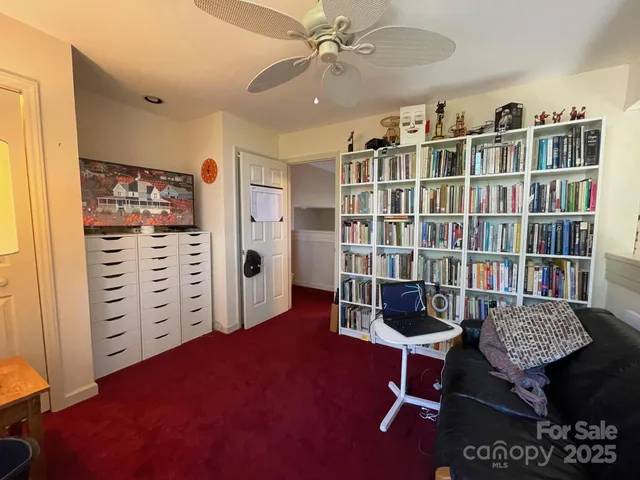 a livingroom with a bookshelf and a workspace