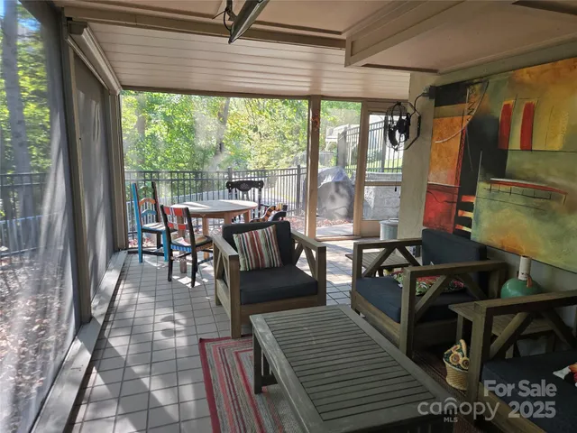 a outdoor space with the couches and dining table with the garden view
