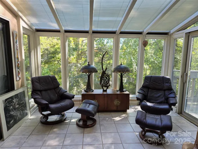 a living room with furniture and large windows