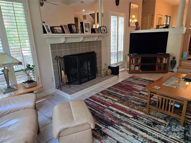 a living room with a fireplace and a flat screen tv
