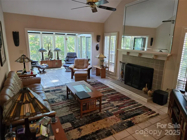 a living room with furniture fireplace and a table