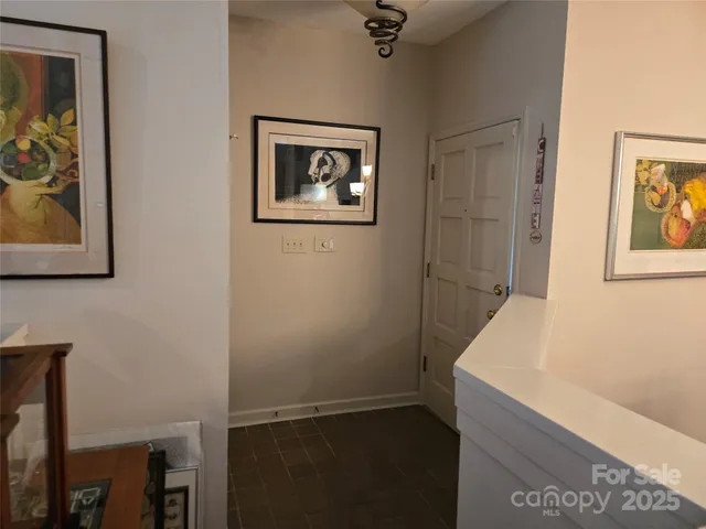 a view of a hallway with paintings on the wall