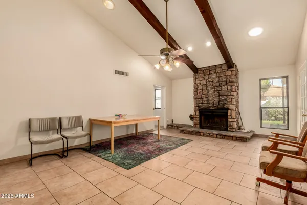 a living room with furniture a fireplace and a table
