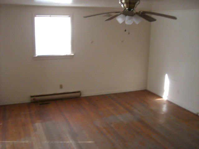 851 Cumslo Road Gray, GA 31032 - Photo 5 of 17 an empty room with a ceiling fan and a window