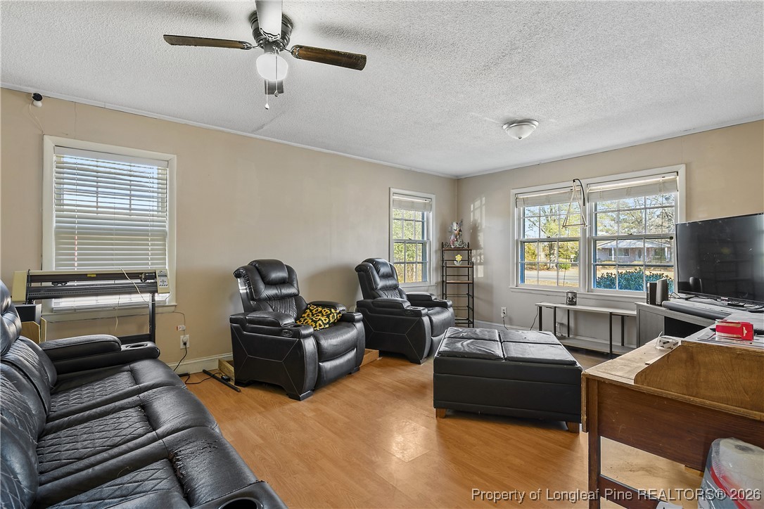 1408 Seabrook School Road Fayetteville, NC 28312 - Photo 11 of 44 a living room with furniture and a flat screen tv